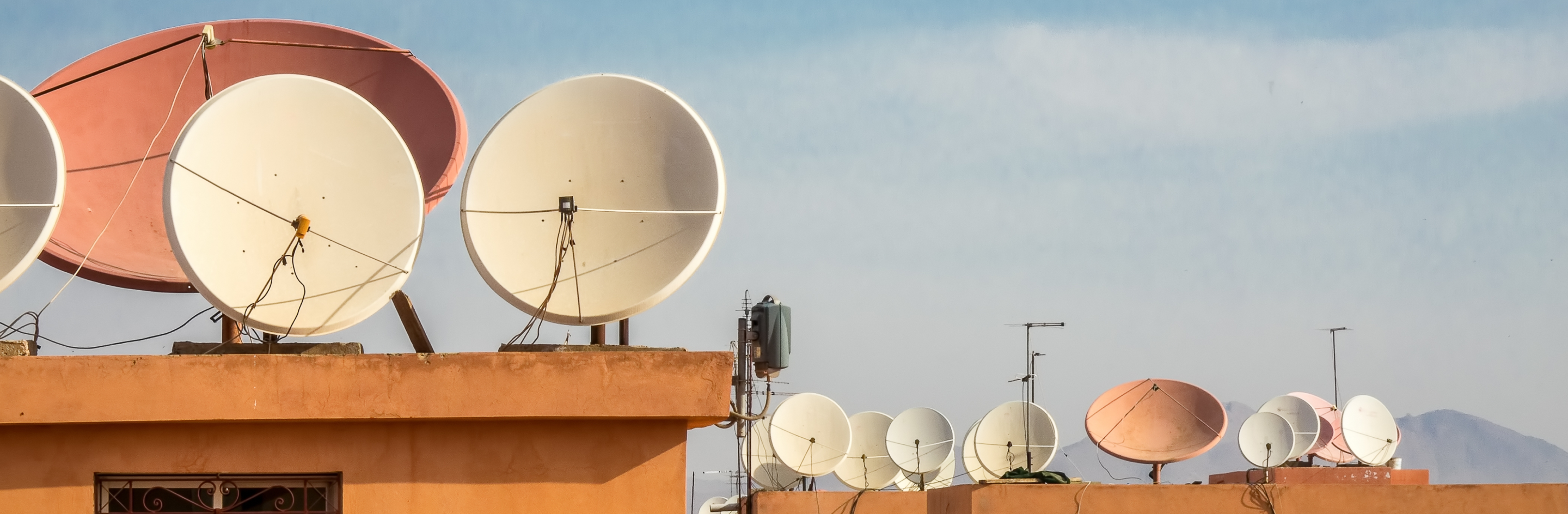 satellites dishes on top of houses